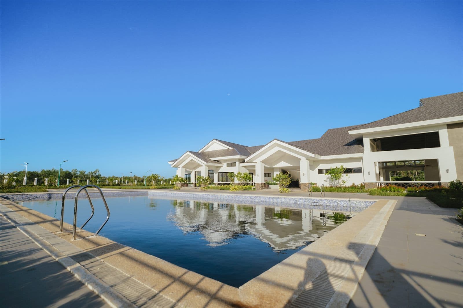 Los Rayos community clubhouse with a resort-style swimming pool