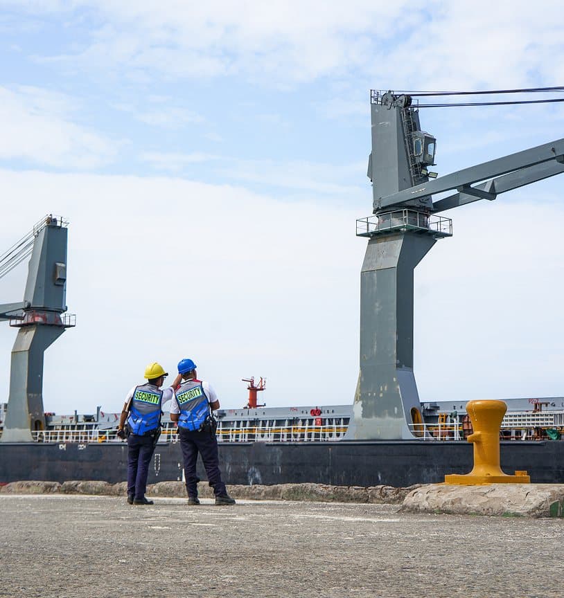 Security personnel and cranes at Hijo International Port